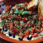 Delicious Bruschetta Dip served with crusty bread and fresh basil garnish