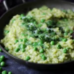 Creamy risotto infused with fresh spring peas, ready to serve.
