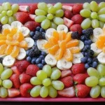 Creative kids food platter with various fruits shaped playfully, perfect for engaging young eaters.