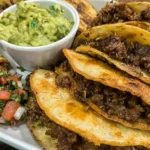 Golden-fried crispy beef tacos, ready to be enjoyed