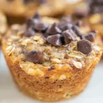 Multiple banana oatmeal muffins cooling on a wire rack, showcasing their texture.