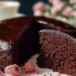 Close-up of a rich, moist chocolate cake with smooth chocolate ganache