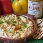 Close-up of a rich, creamy banana pepper chicken dip, ready for dipping.