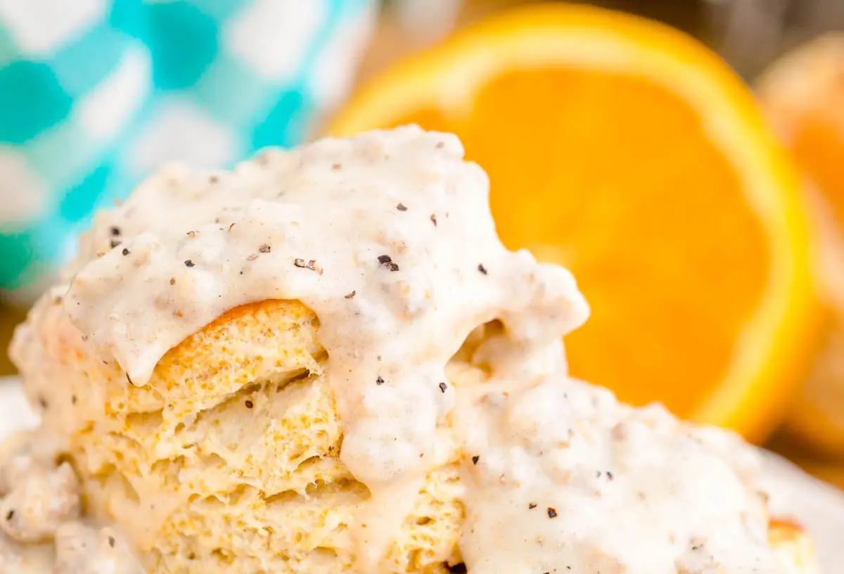 Biscuits and Gravy: 5 Easy Recipes 2 Fluffy biscuits drenched in creamy sausage gravy on a white plate